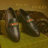 Gucci loafers on a Gucci branded box with a gold background